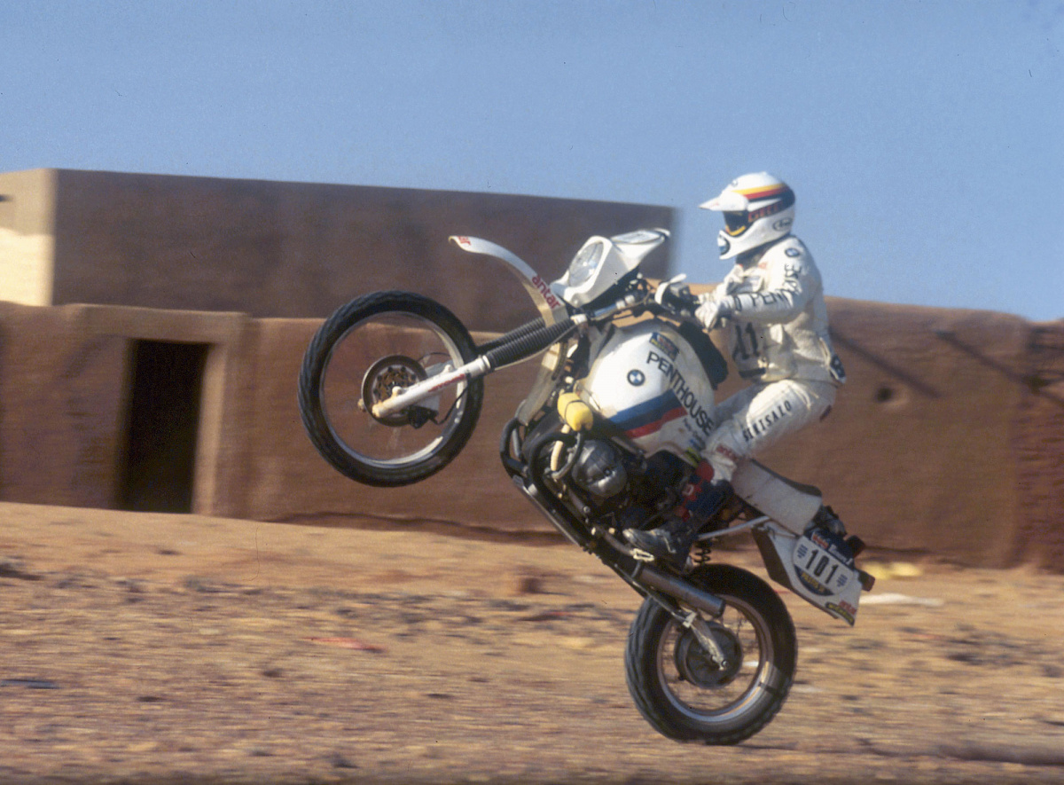 Gaston Rahier wheelies on a BMW motorcycle