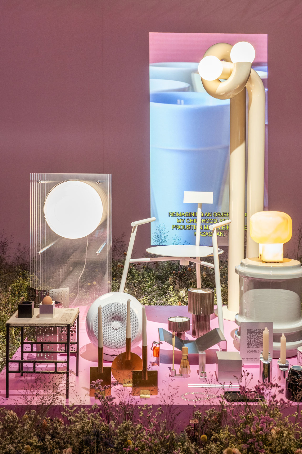 Retail display vignette with chrome lamps and dried flowers in a plum colored room