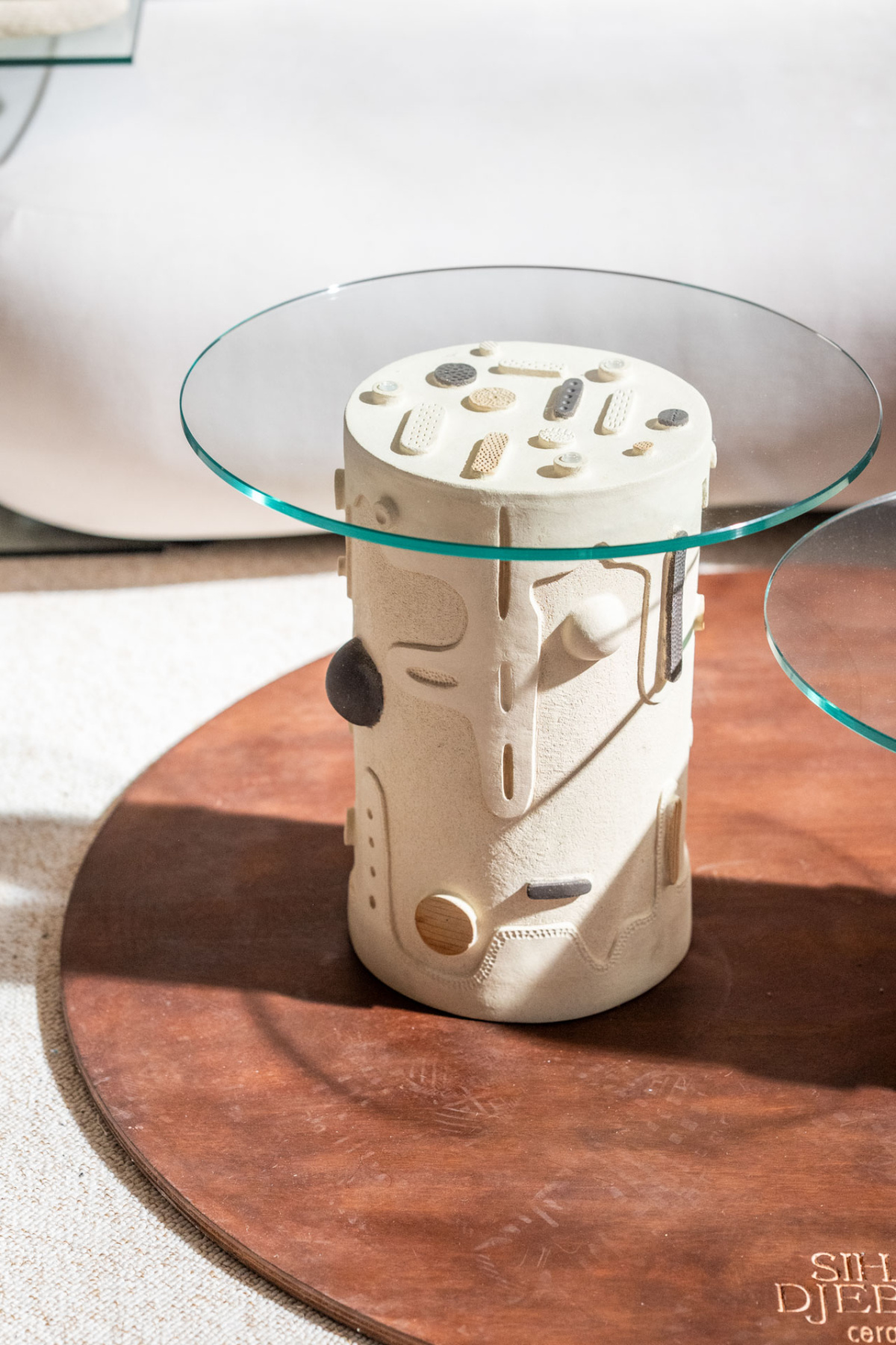 Cylindrical stoneware side table with a round glass top