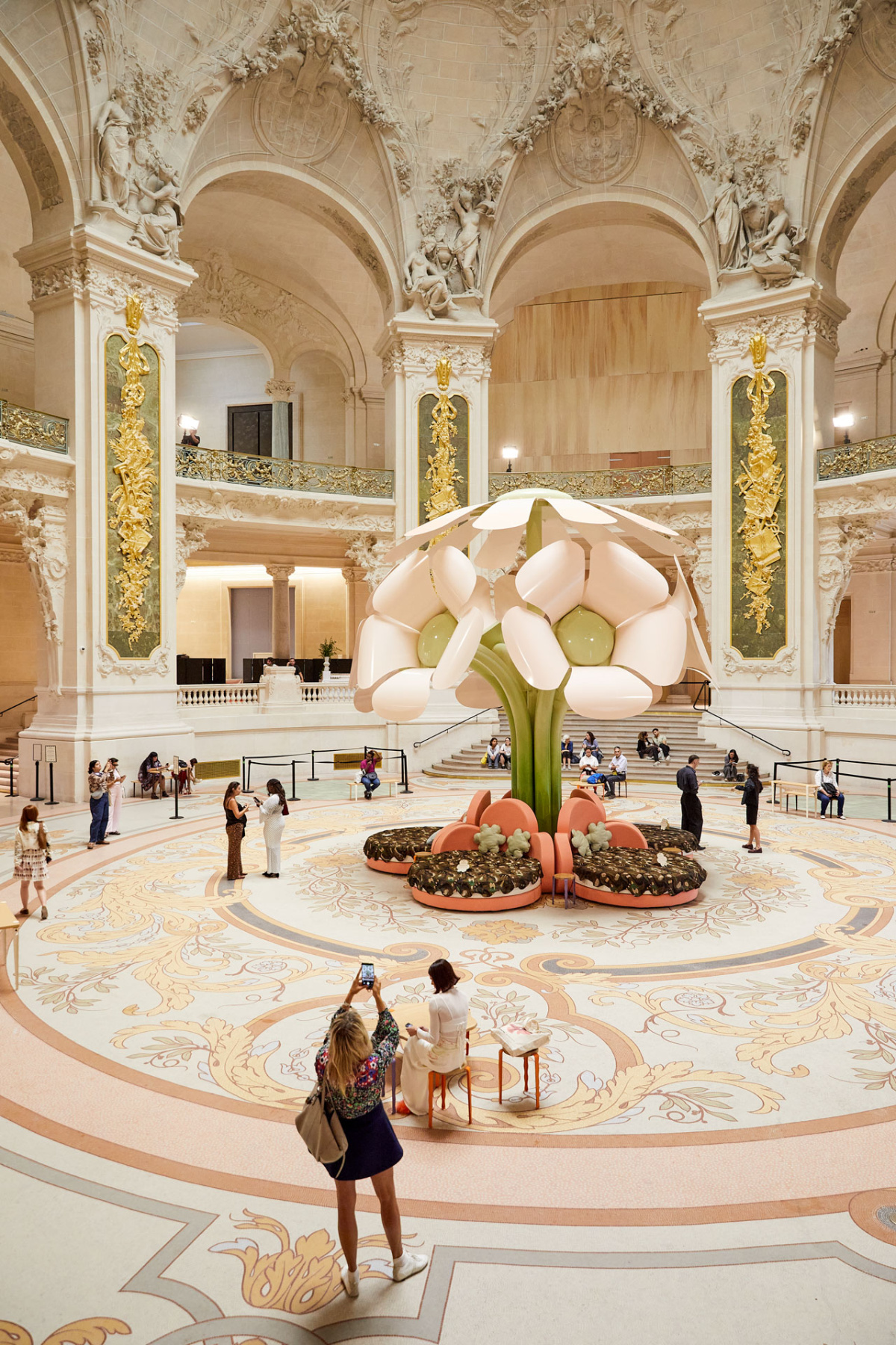 Giant pink and white flower sculpture inside the Grand Palais rotunda