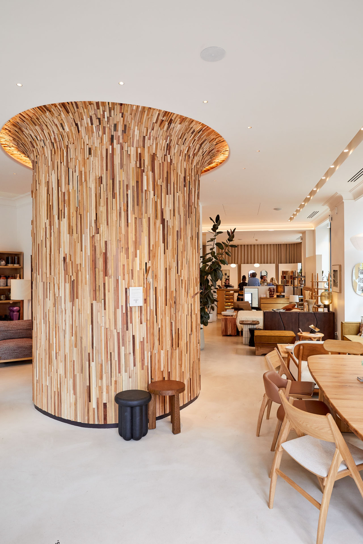 Column covered in small wooden sticks inside a furniture store