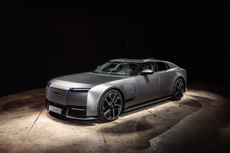 The silver Jaguar Type 01 under a spotlight at STORIED in Chelsea, where Jaguar unveiled it.