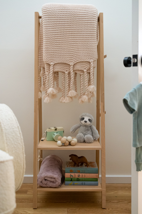 Kathy Kuo Home clothing rack for nursery.